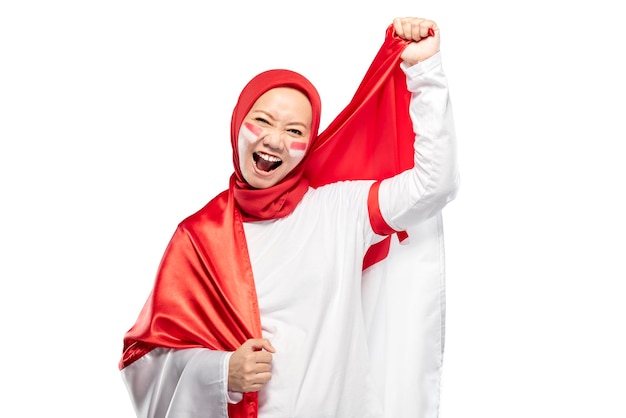 Indonesian women celebrate Indonesian independence day on 17 August by holding the Indonesian flag