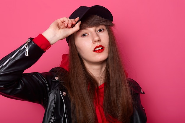 Indoor shot of happy Caucasian young teenager girl in red hoodie