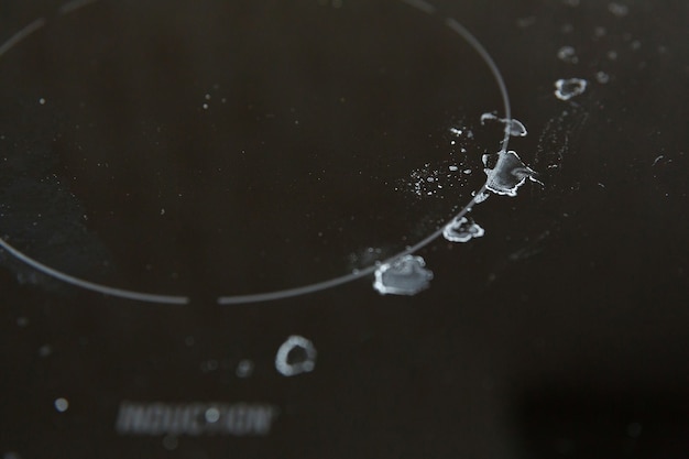 Induction cooker in burnt dried drops of water.