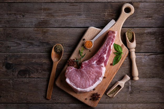 Indulge in the rustic charm of a raw piece of pork loin on a wooden board