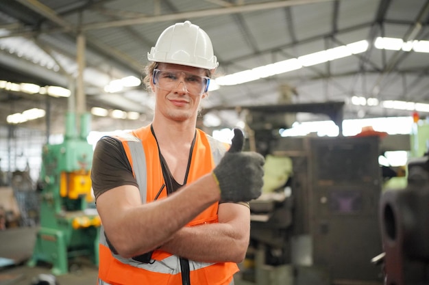 Industrial background of caucasian mechanics engineer operating lathe machine for metalwork in metal work factory