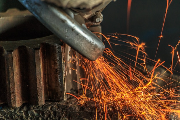 Industrial background, industry, Sparks from grinding machine in workshop. 