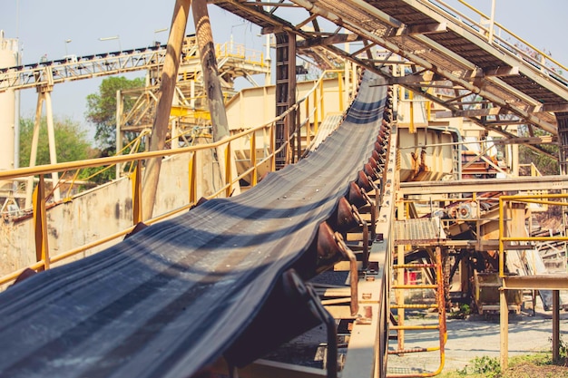 Industrial belt conveyor moving raw materials from mine gold