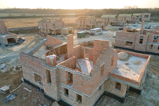 Industrial building site in rural area with residential houses under construction for future sale or leasing Concept of real estate development