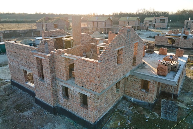 Industrial building site in rural area with residential houses under construction for future sale or leasing Concept of real estate development