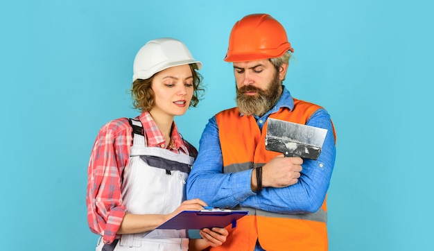 Industrial business partner. job and occupation. confident electrical and technician. engineers couple working together on building blueprint. work at construction site or factory. Civil engineering.