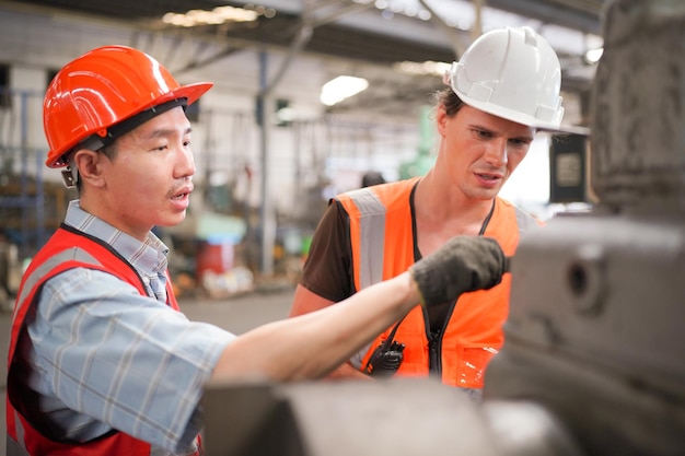 Industrial Engineers in Hard HatsWork at the Heavy Industry Manufacturing Factoryindustrial worker indoors in factory man working in an industrial factory