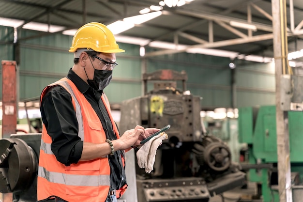 Industrial factory concept. Engineering working on mobile phone. Worker operating and maintenance of machinery.