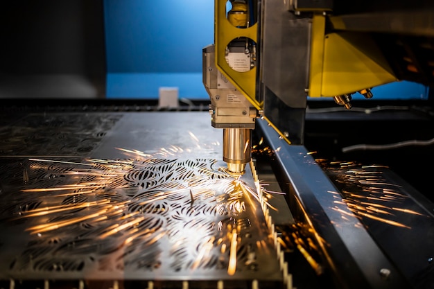 Industrial laser machine cuts out parts in sheet steel.