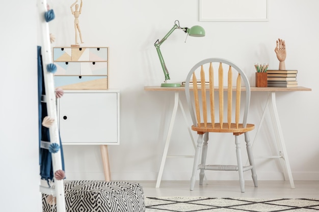 Photo industrial mint colored lamp on stylish wooden desk in white kid39s bedroom