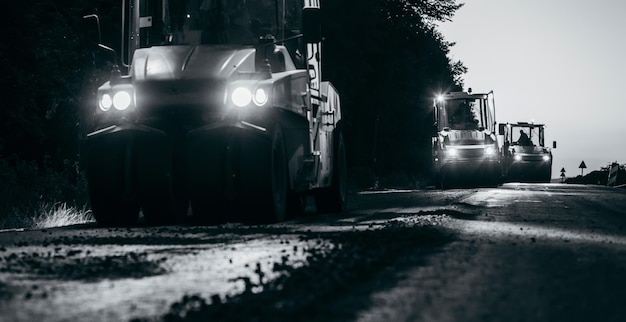 Industrial pavement truck is laying fresh asphalt on construction site Road service repairs the hig