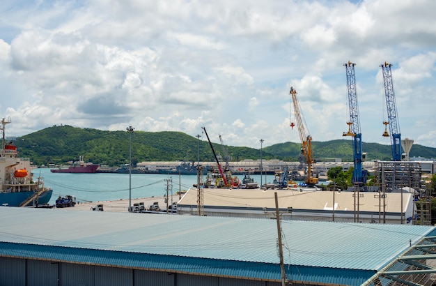 Industrial port crane lift up loading export containers box onboard at port of Thailand