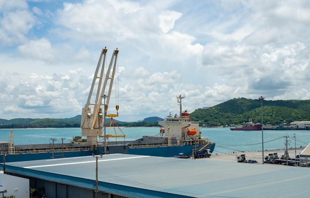 Industrial port crane lift up loading export containers box onboard at port of Thailand