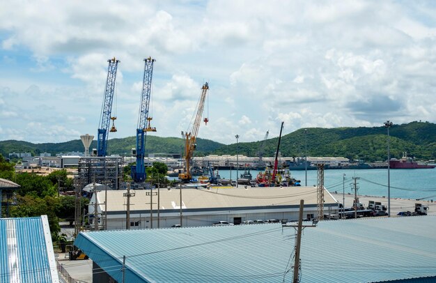 Industrial port crane lift up loading export containers box onboard at port of Thailand