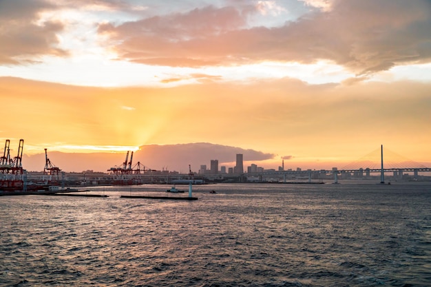 Industrial port harbor crane in yokohama Sunset for Modern transportation business and global commercial concept