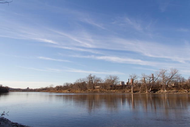 Industrial site behind a large body of water Winnipeg Manitoba