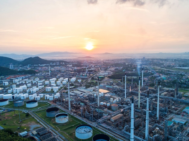 Industrial view at oil refinery plant form industry zone with sunrise and cloudy sky.