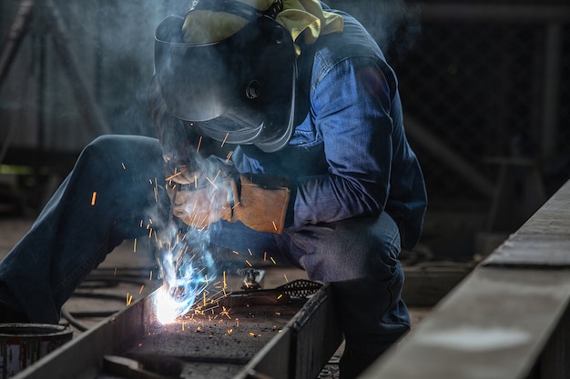 Industrial Worker at the factory Steel welding closeup, Welder 