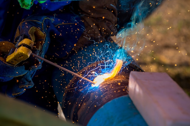 Industrial Worker at the factory welding closeup