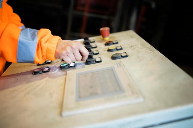 Industrial worker operating factory control panel