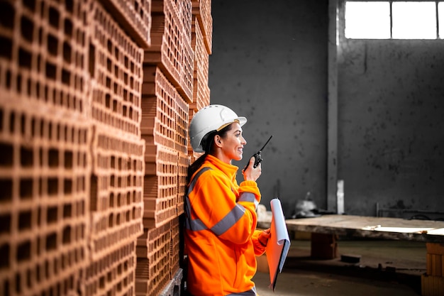 Industrial worker in protective equipment controlling production via radio communication set