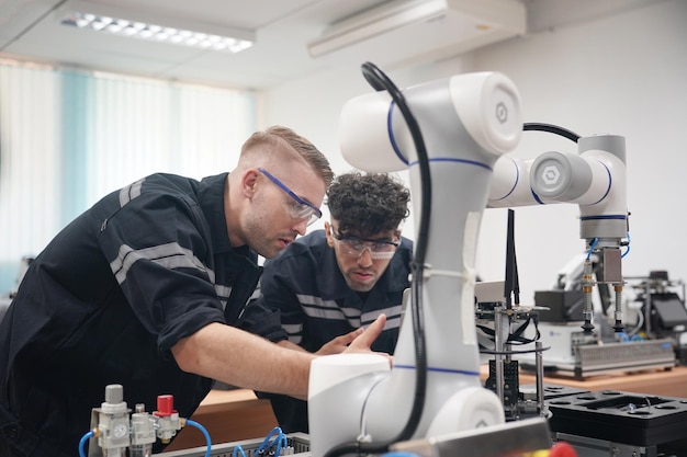 Industry 40 Young engineer works at a robotic arm