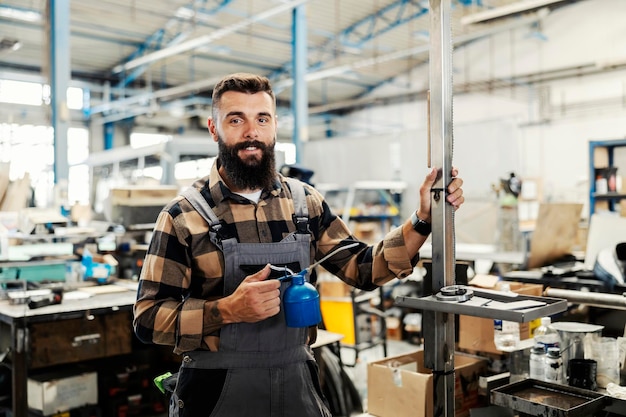 An industry worker checking on bus construction in vehicle production factory