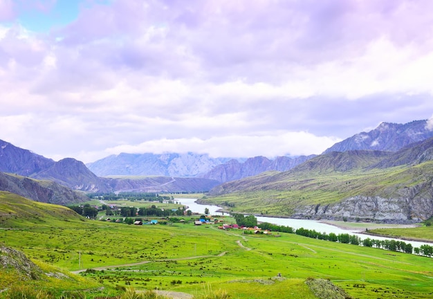 Inegen village in a mountainous landscape under a blue cloudy sky Siberia Russia