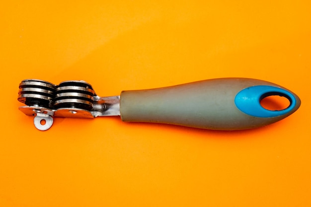 Inexpensive Knife sharpener isolated on an orange background