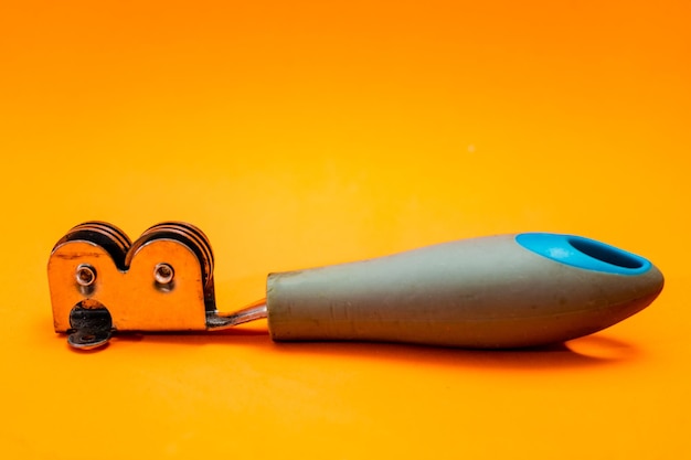 Inexpensive Knife sharpener isolated on an orange background