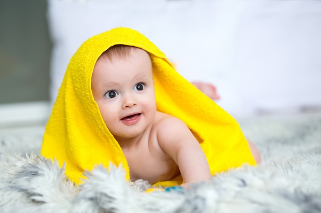 Infant baby boy crawl with towel