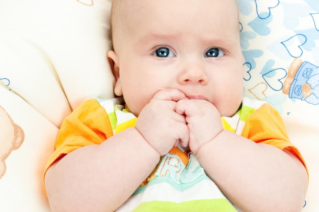 Infant with hands in mouth