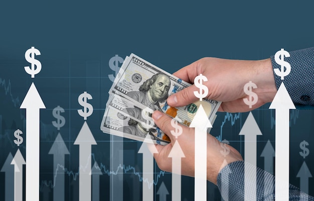 Inflation hands with banknotes of American dollars against the background of arrows and dollar signs concept of decreasing purchasing power inflation inflation in united states and europe