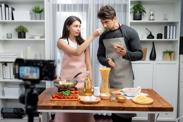 Influencers on cooking show presenting ingredient of spaghetti dish postulate