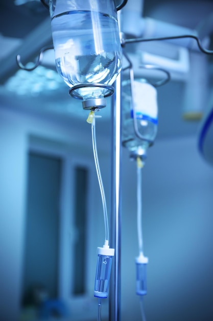 Infusion drip in hospital on blurred background