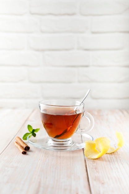 Infusion of hot tea with lemon and cinnamon