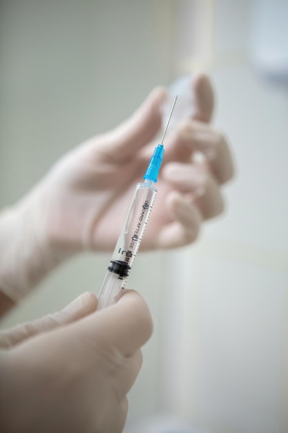 Infusion syringe in the hands of a nurse Selective focus