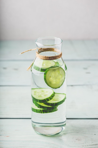 Infusion with sliced cucumber in glass bottle