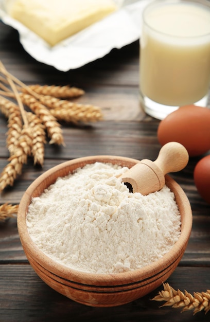 Ingredients for baking or cooking egg flour rolling pin butter milk on a grey wooden background Cookie pie or cake recipe