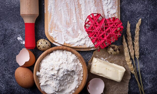 Ingredients for baking. Egg, flour, sugar and butter. Top view, space for text