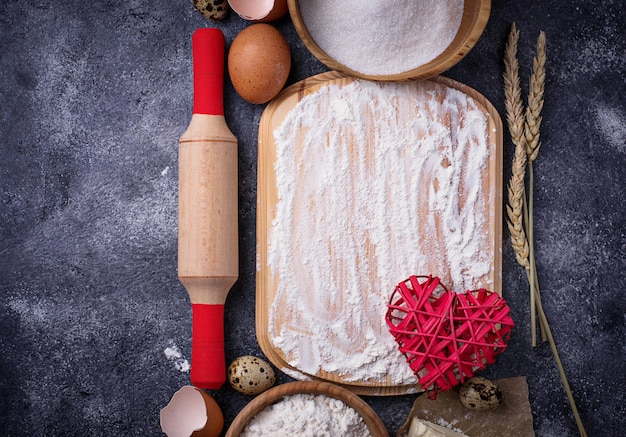 Ingredients for baking. Egg, flour, sugar and butter. Top view, space for text