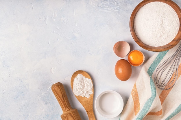 Ingredients for baking flour wooden spoon eggs