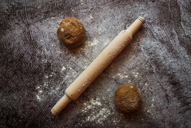 Ingredients for baking rye buns rolling pin lie on a gray table