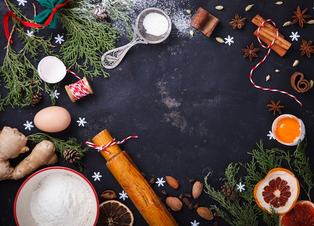 Ingredients for Christmas baking on black background