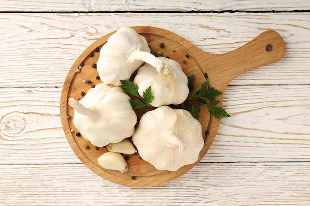 Ingredients for cooking garlic sauce on white wooden background