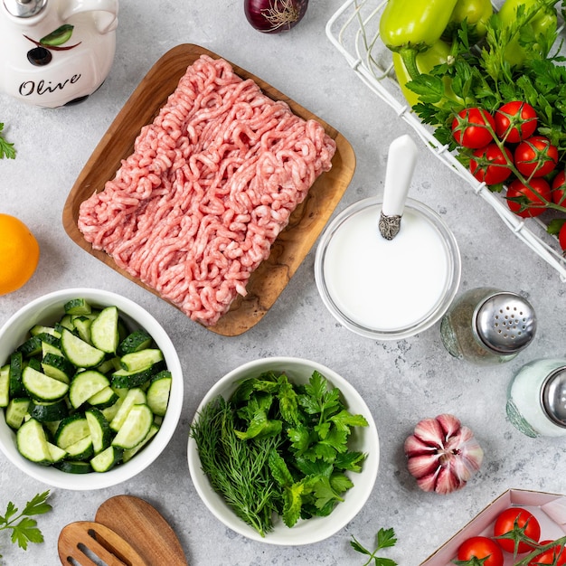 Ingredients for cooking Greek meatballs with salad and tzatziki sauce