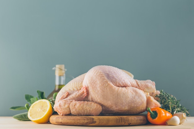 Ingredients for cooking on kitchen table with chicken and vegetables