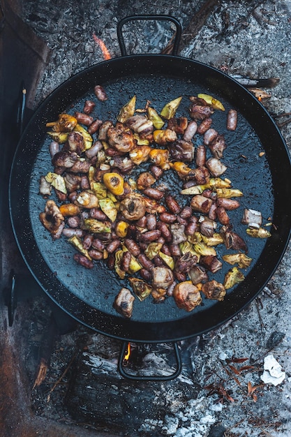 Ingredients for cooking a paella artichokes chicken sausagesSpanish typical food