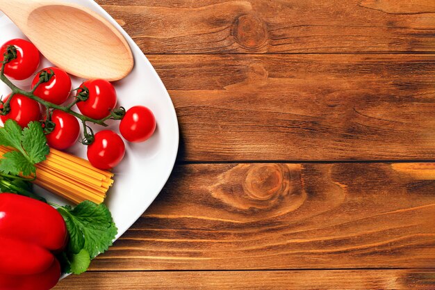 Ingredients for cooking pasta on wooden table