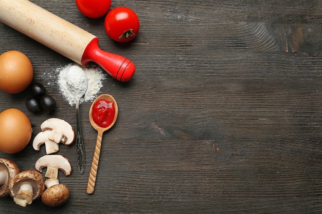 Ingredients for cooking pizza on wooden table top view